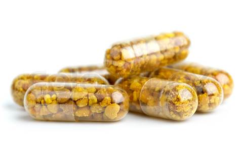 Some homeopathic pills with bee pollen isolated on the white background